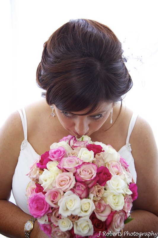 Bride smelling flowers - wedding photography sydney